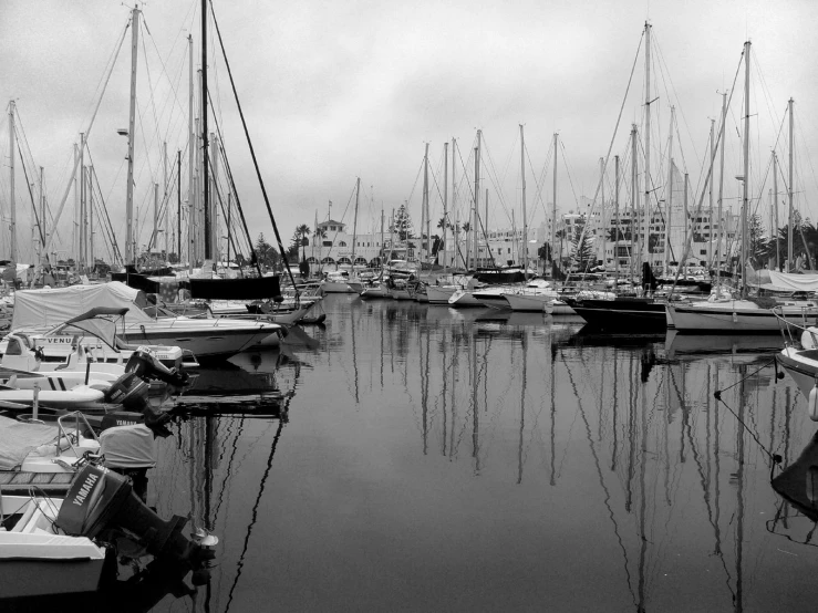 a black and white po of boats in harbor