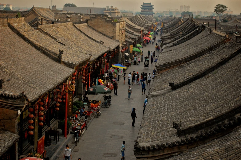 an overview view of a city area with a group of buildings, and a walkway between the houses