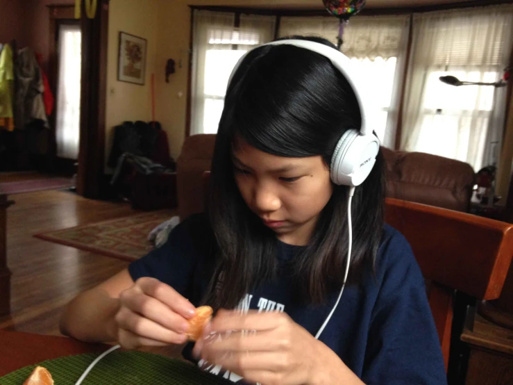 a  wearing headphones sitting in a chair