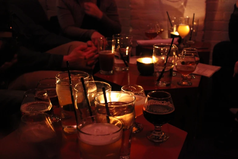 people drinking beer around a bar table