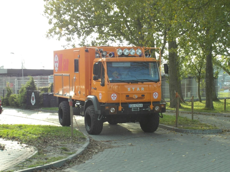 an orange work truck is parked in the street