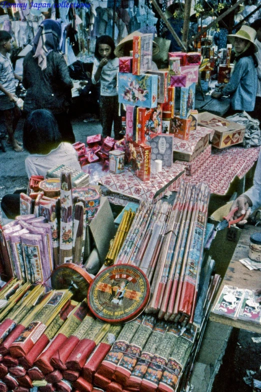 an outdoor vendor in front of some boxes and boxes