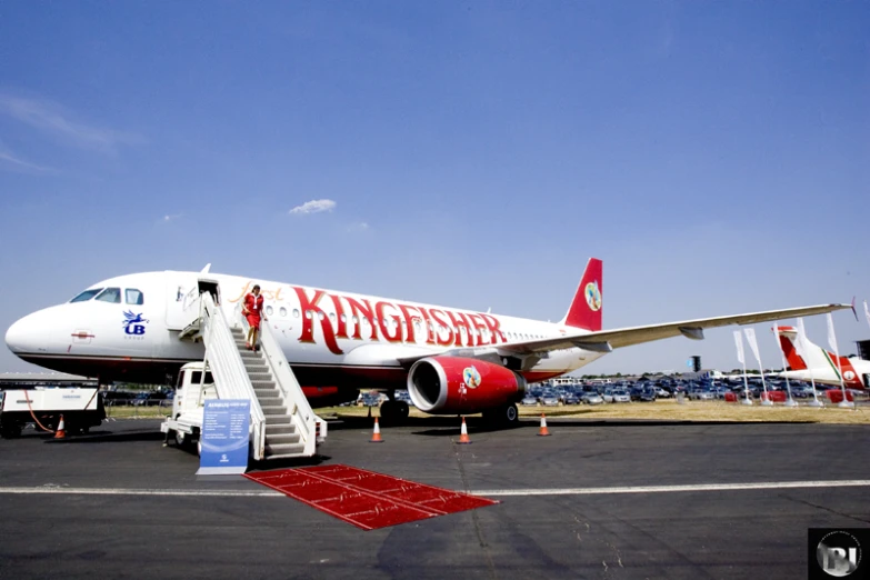 the large red and white plane is on the runway