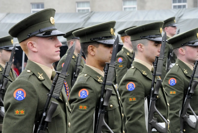many soldiers in uniforms line up in formation