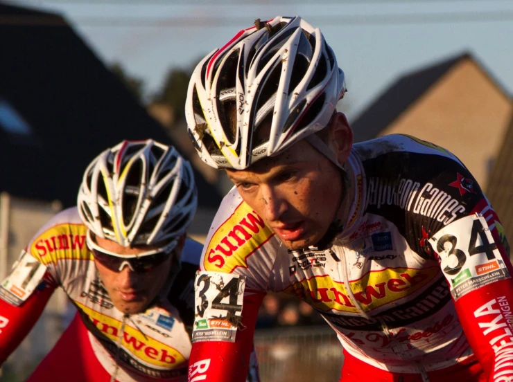 two men with helmets on in a race