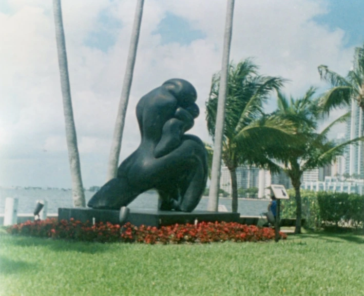 a statue on a lawn near the ocean