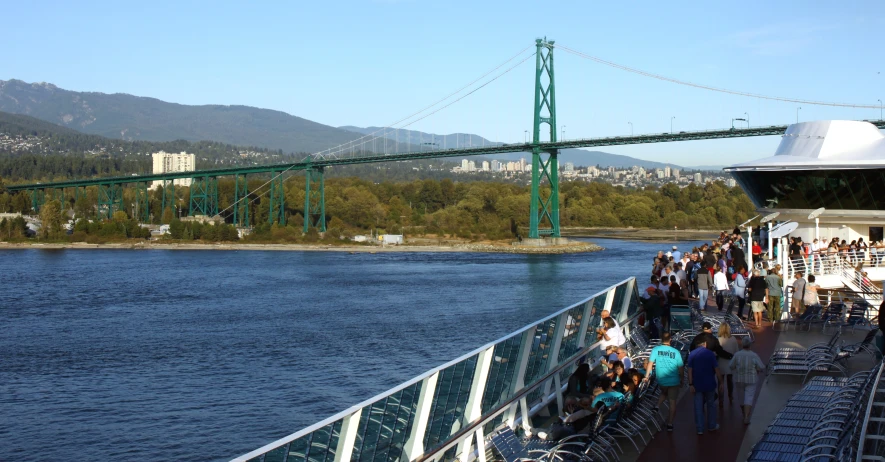 a large crowd of people are walking on a ferry