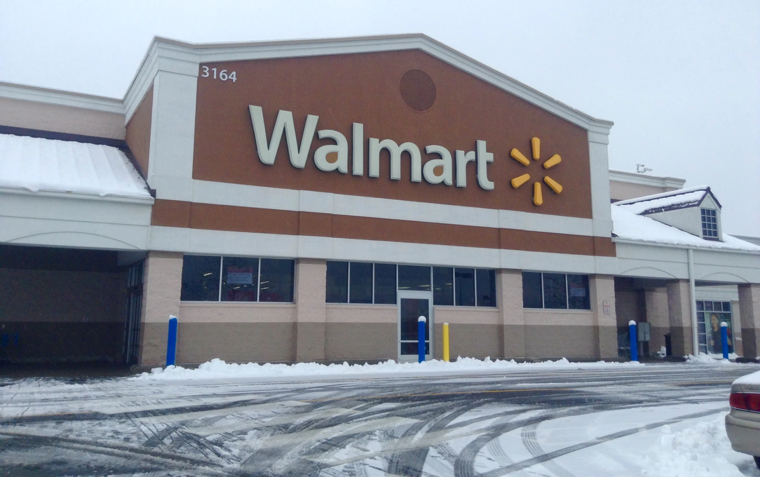 a store with a snow covered parking lot