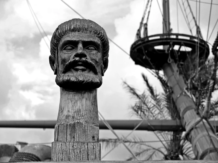 a carved head of a man next to a large tower