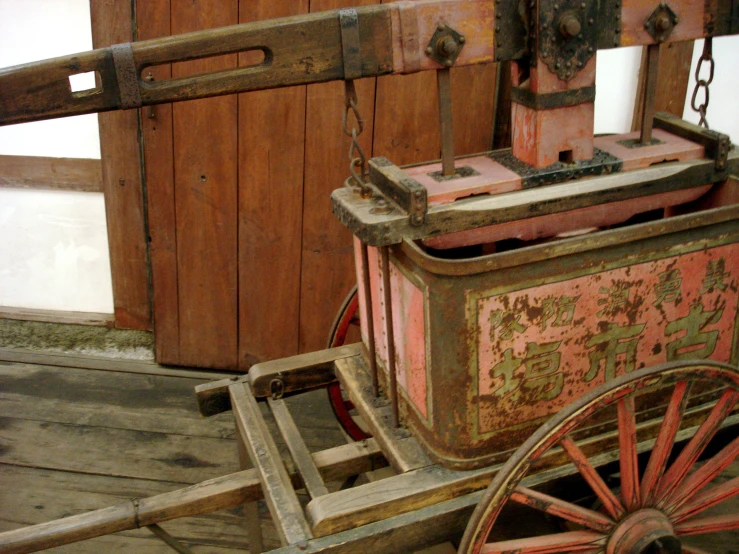 a rusted wagon sits outside of a house