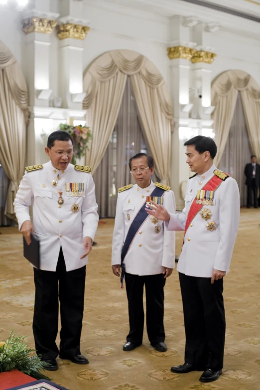 two men in uniforms presenting a flag to another man