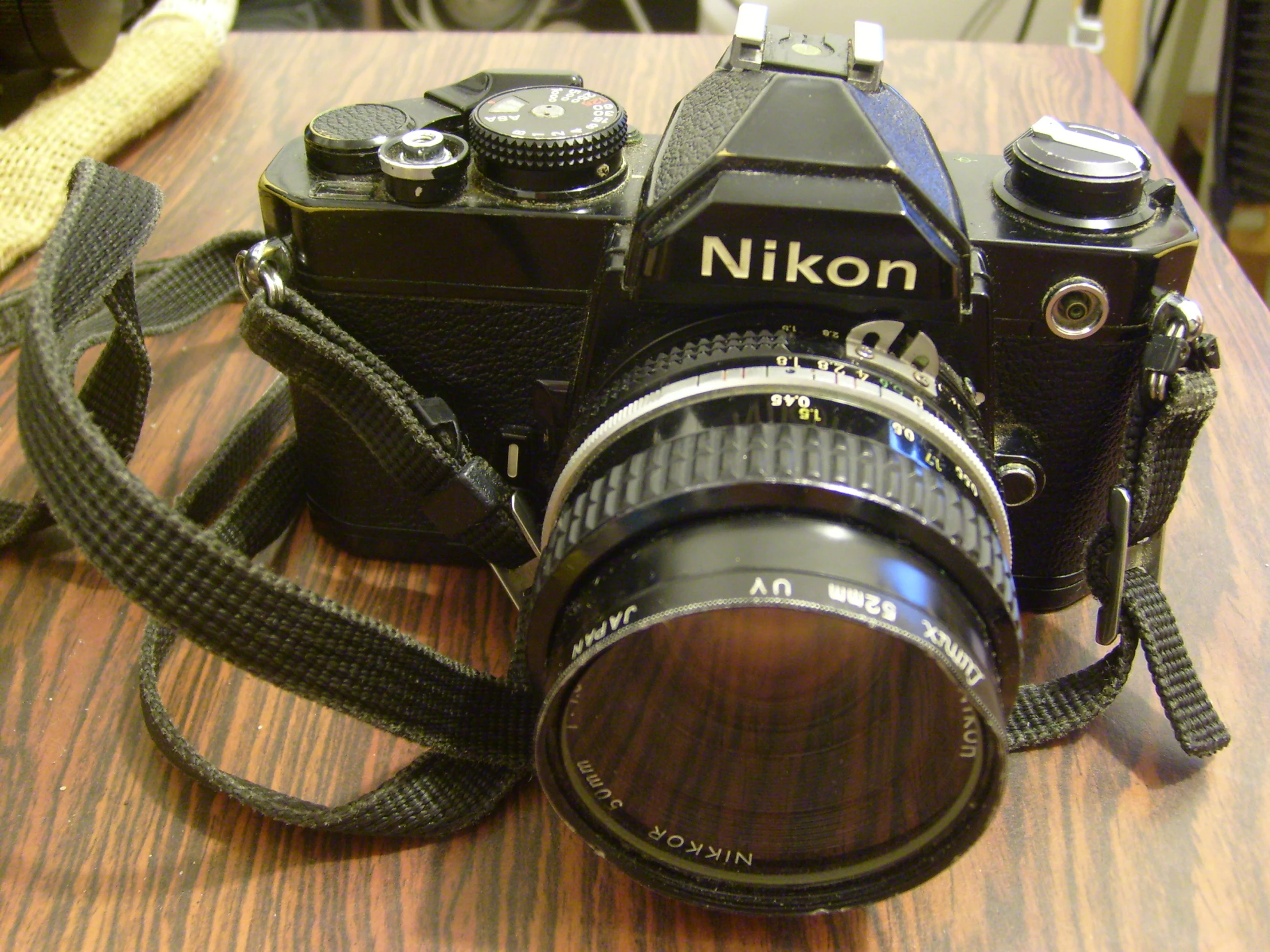 there is a brown camera and a black camera on a table