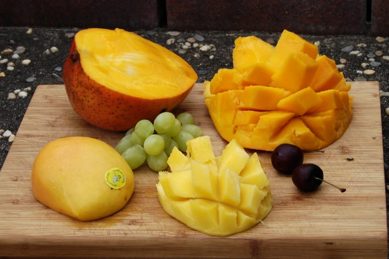 fruit on a wooden board cut and whole