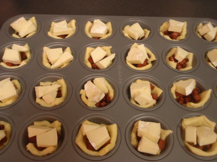 a muffin tin filled with many small bites