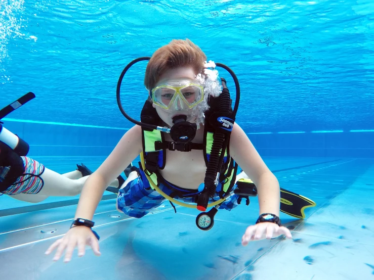 a woman in a diving suit with goggles and snores