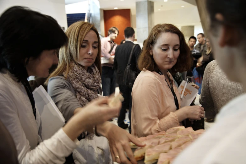 several people are eating and talking while having conversation