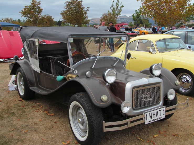 old cars are lined up in the dirt with others