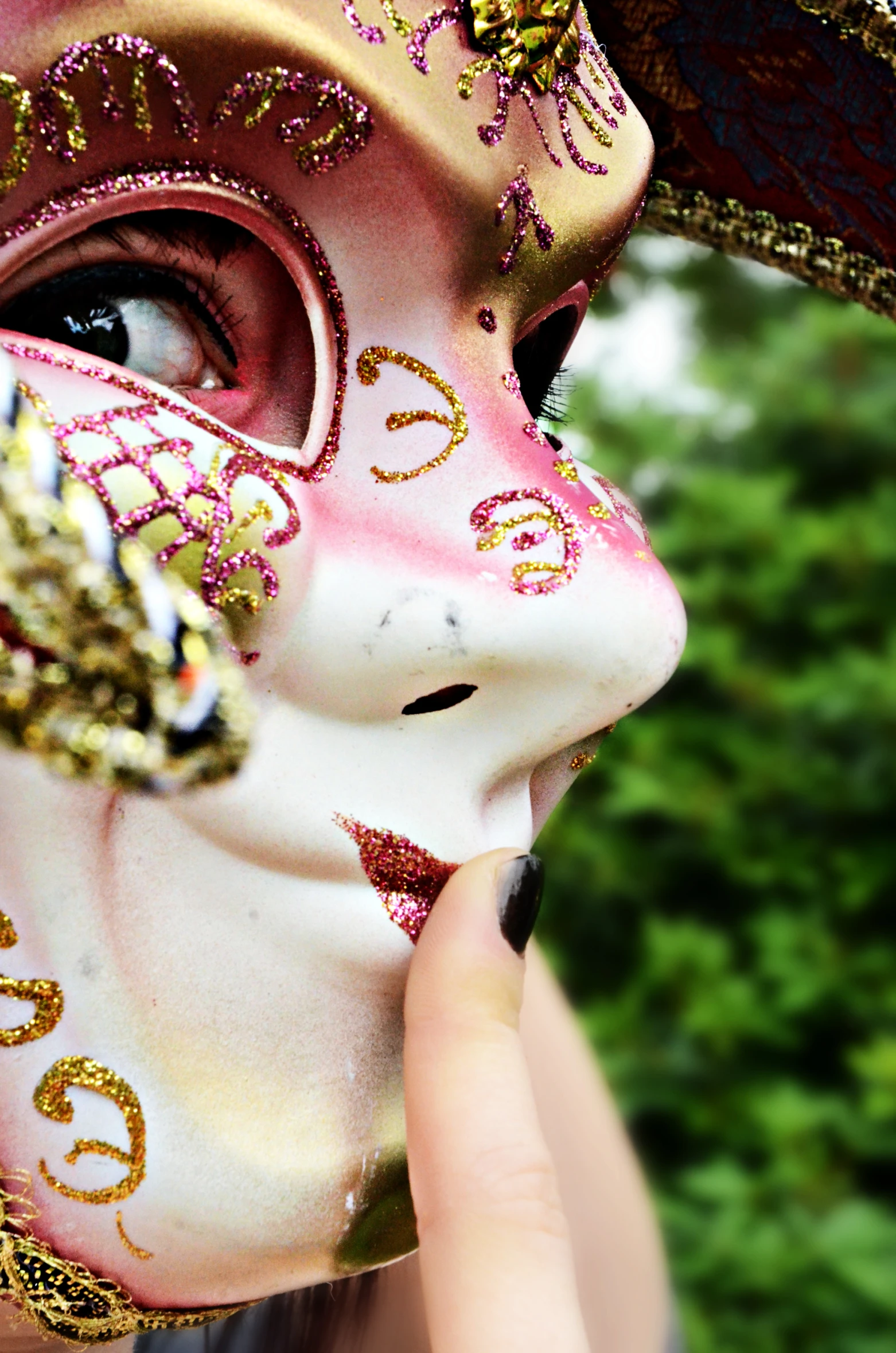 woman in mask blowing bubbles while holding it to face