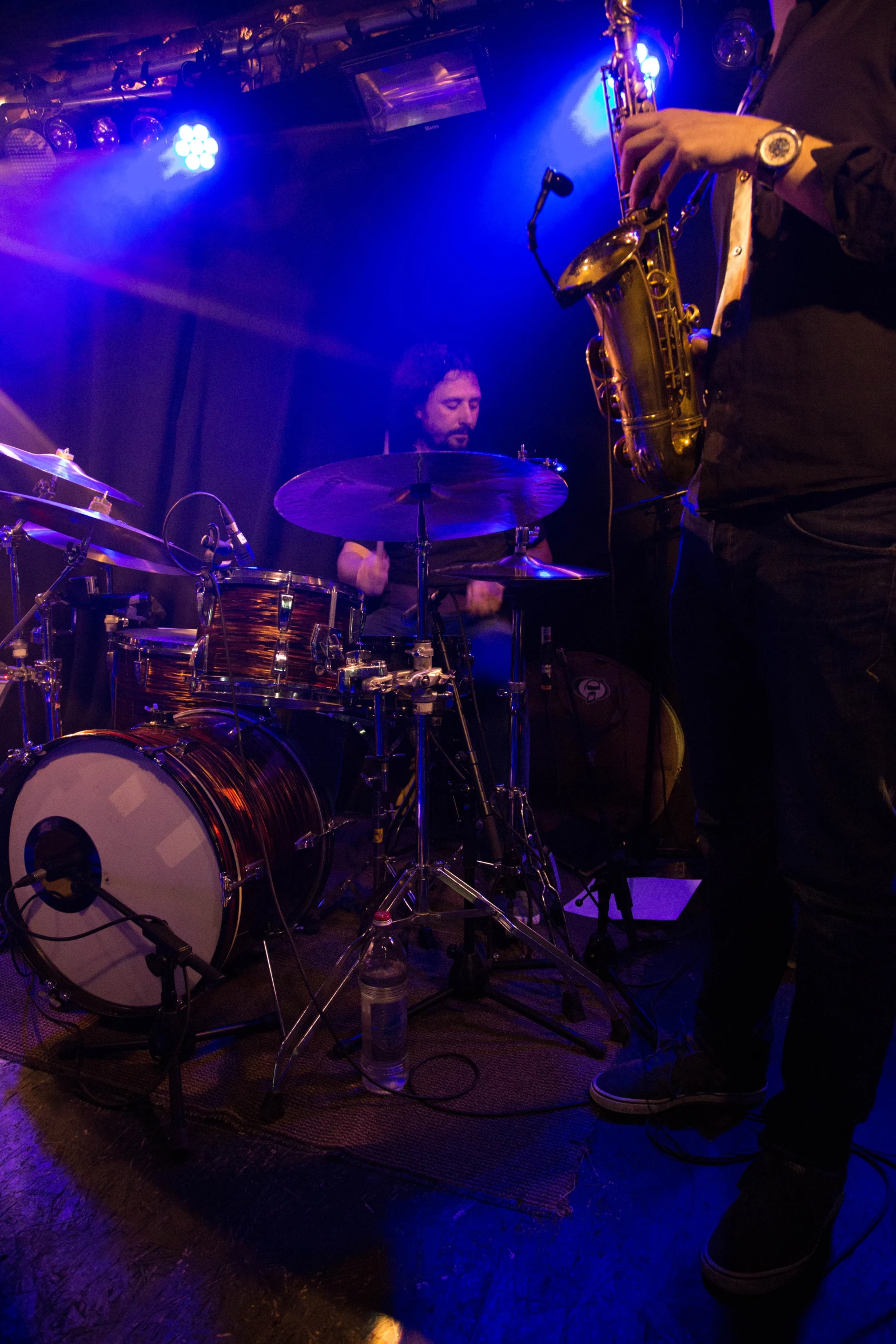 a man is playing instruments on stage at a concert