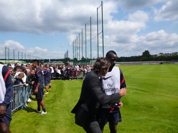 the woman is carrying the young man up to the football field