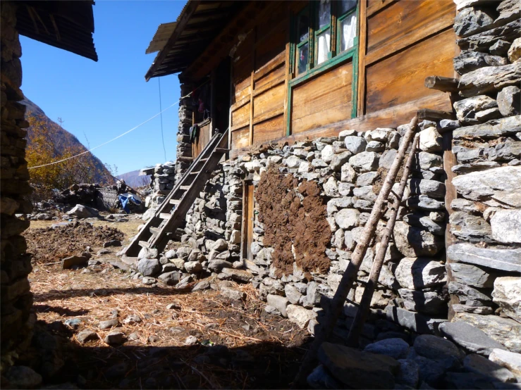 a wooden building with stairs in front of it