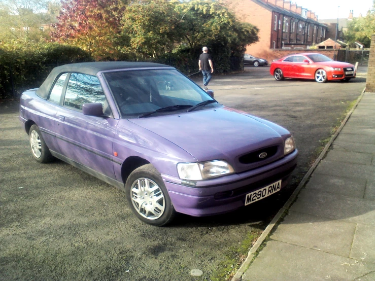 a purple car parked on the side of a road