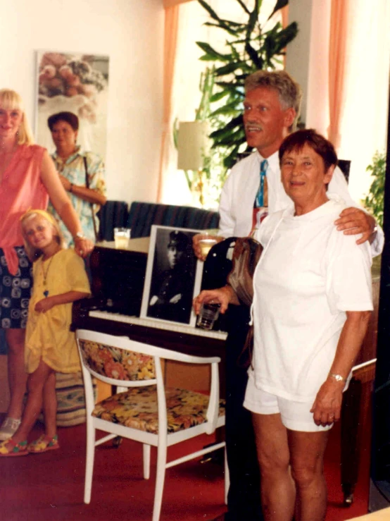 an older couple standing with two younger people