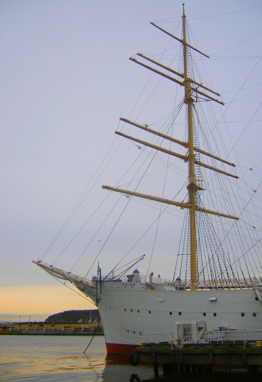 an old sailboat moored in the water