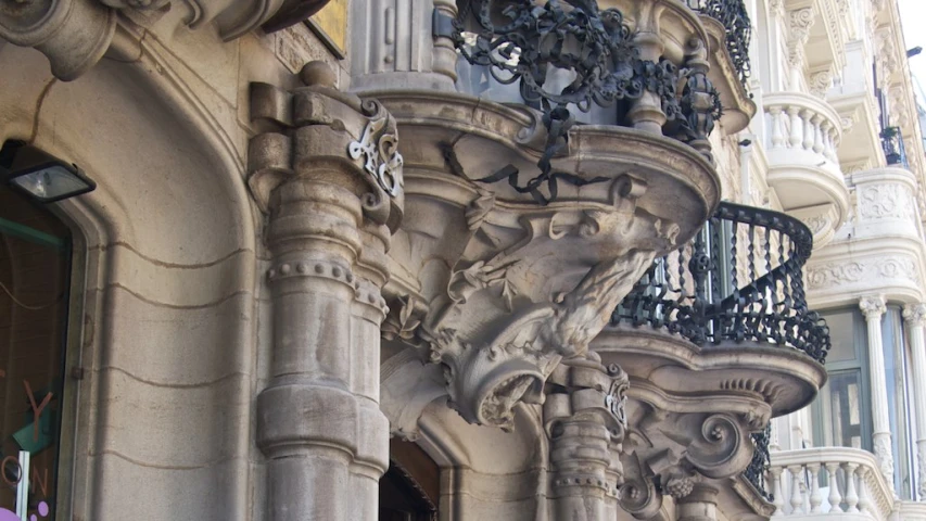 the building has ornate, wrought iron balcony balconies