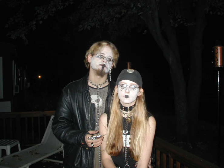 a couple dressed up in costumes standing on porch