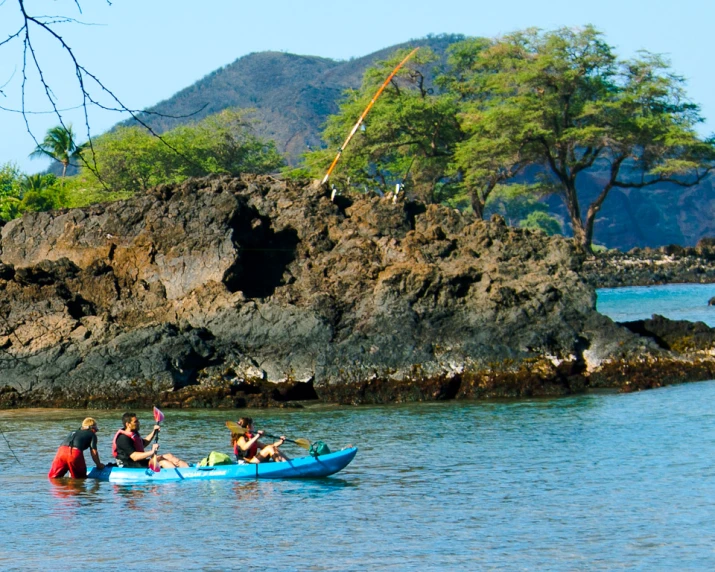 some people sitting on a small boat in a body of water