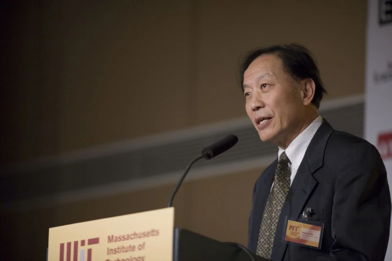 a man stands at a podium while giving a speech