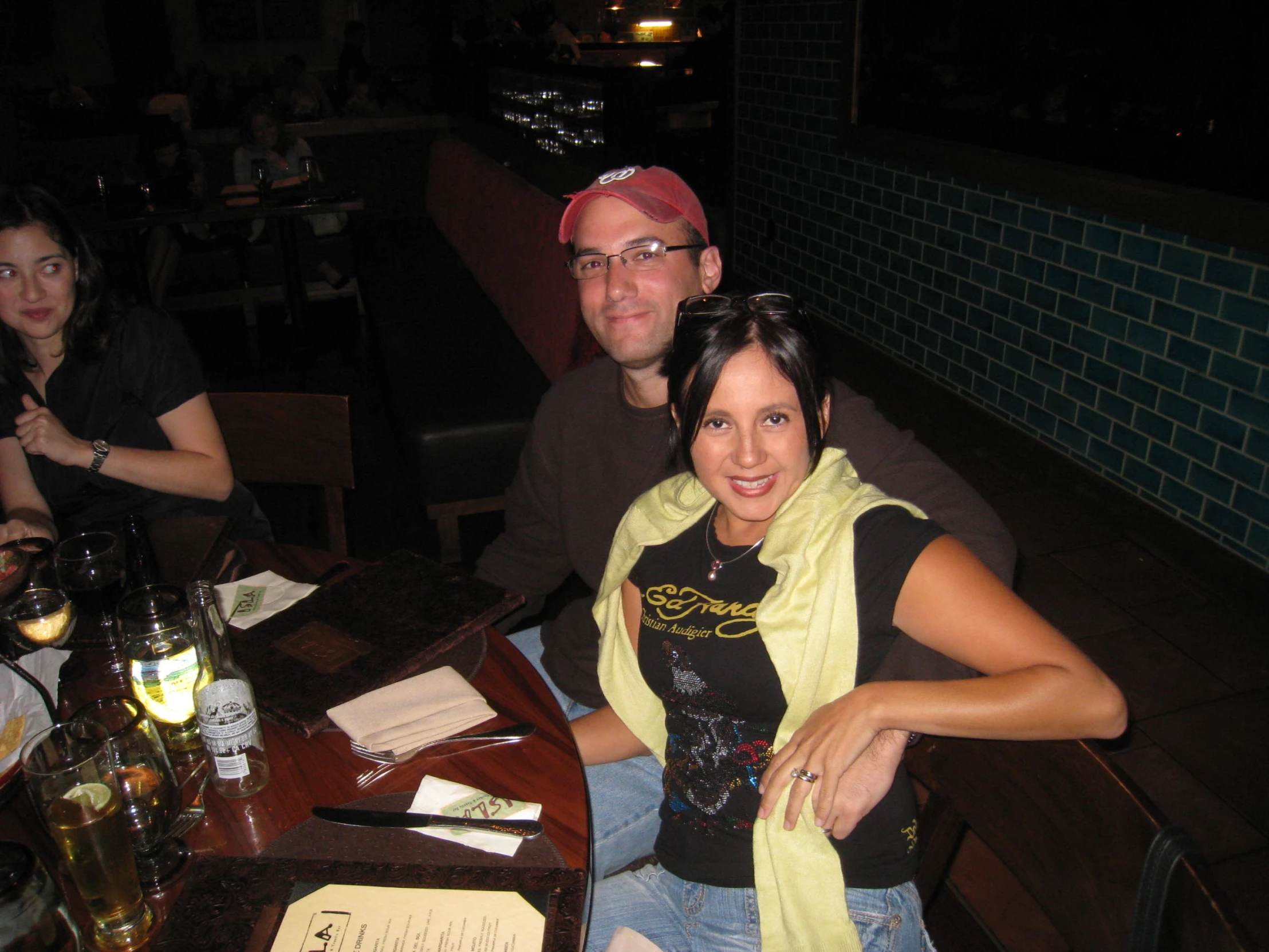 two people are sitting at the table in a bar