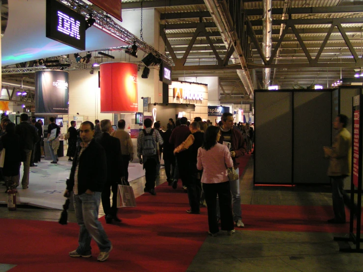 large crowd of people gathered at an indoor convention hall