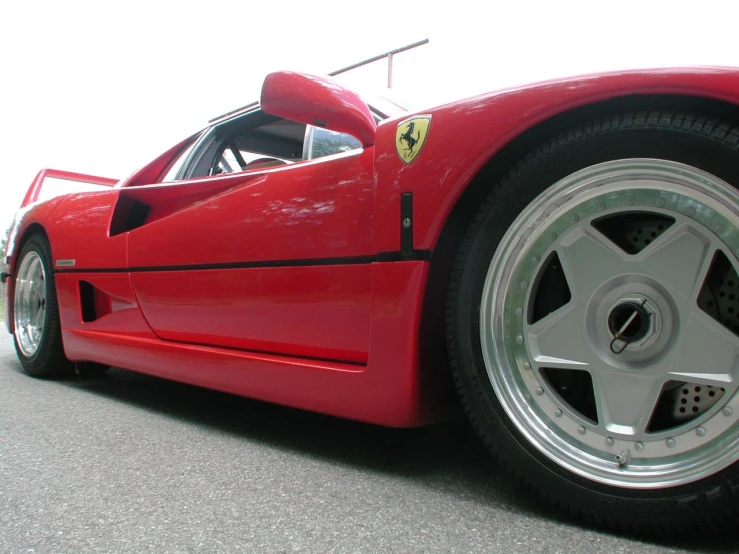 the front wheel and tire of a red car