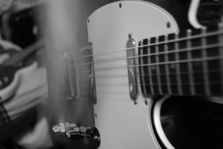 a black and white image of a guitar and its pick - up