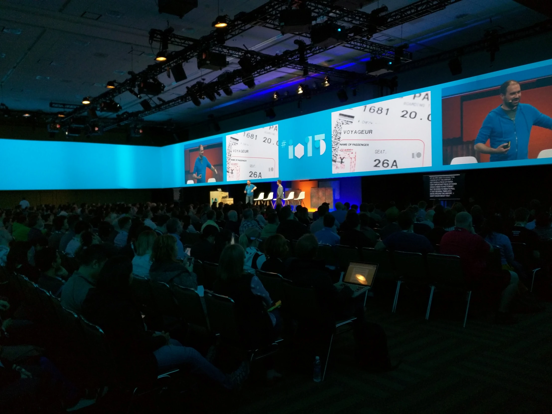 a presentation of what's in the workspace is projected on a wall and a ceiling