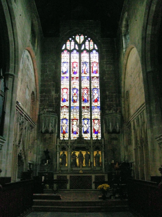 a beautiful stained glass window in an old looking church