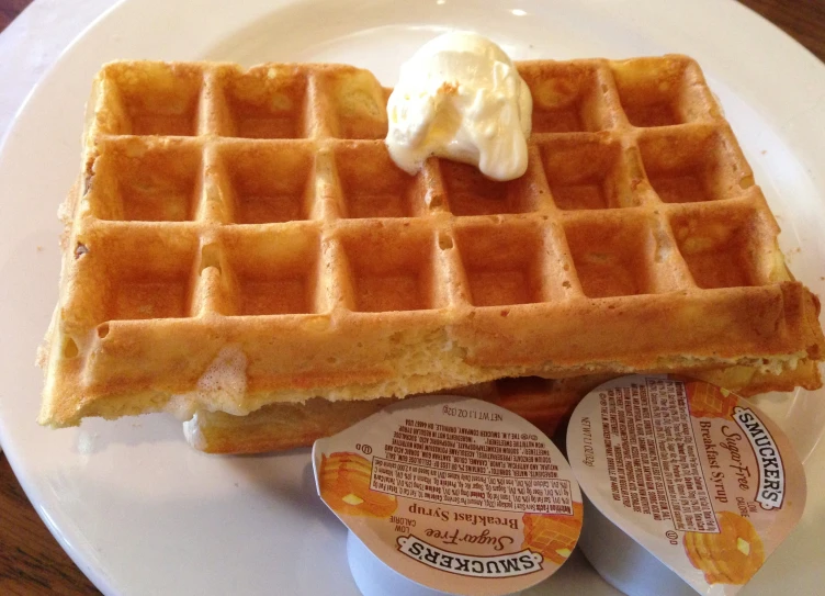 a white plate topped with two waffles and a er knife