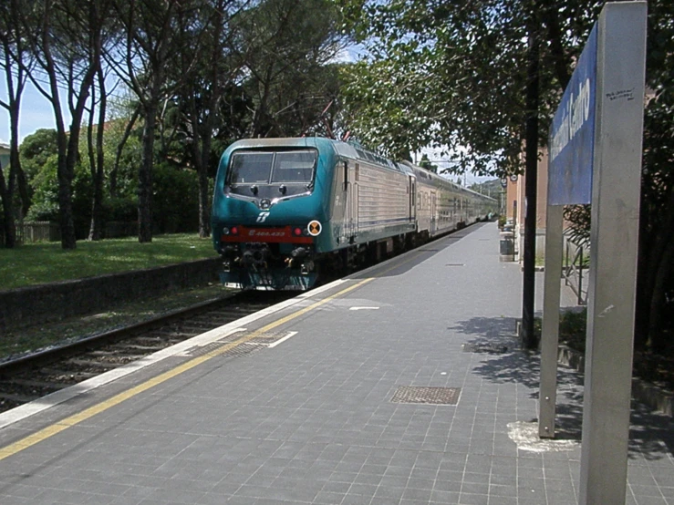 train with doors open on the tracks at a park