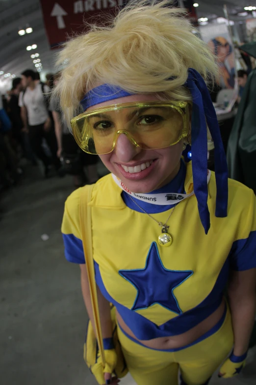 a  in costume with a yellow outfit and blue glasses