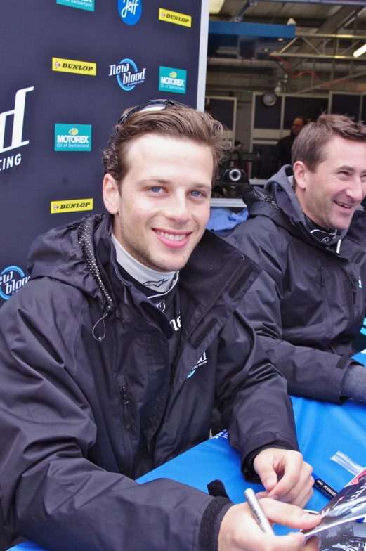 the two men are sitting at a table