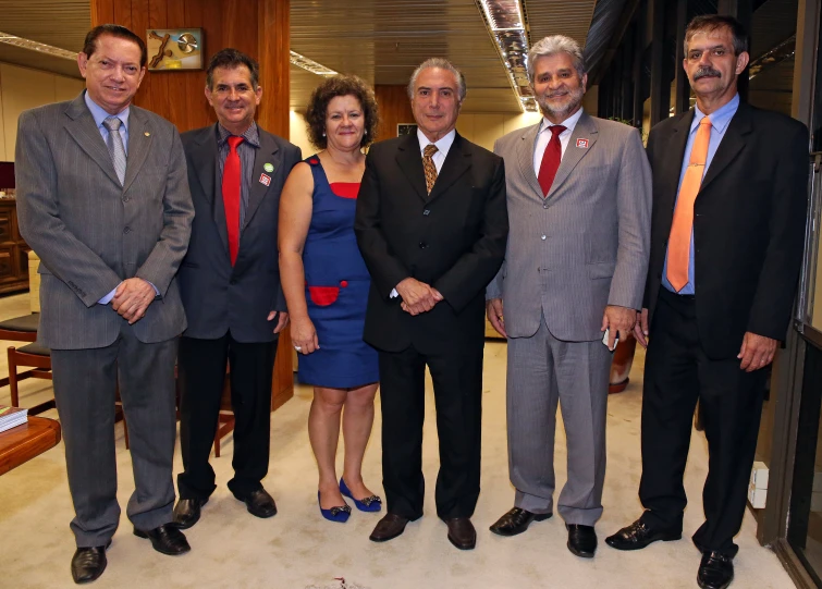 a group of business people standing next to each other