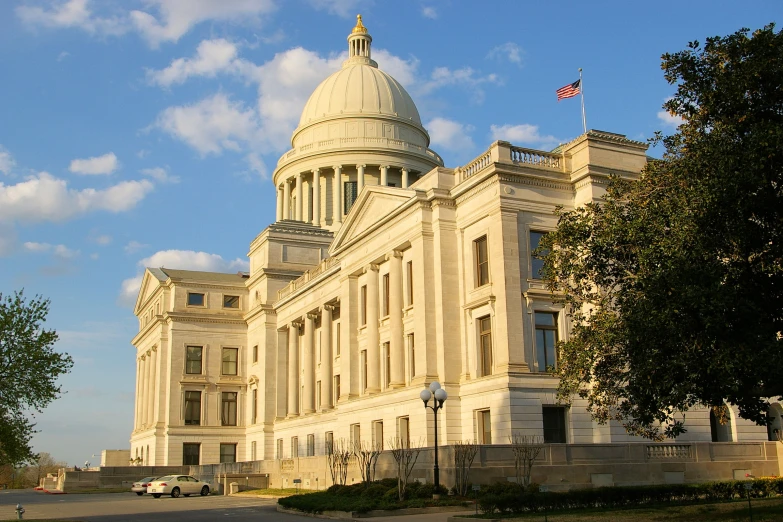 there is a state house building near a parking lot