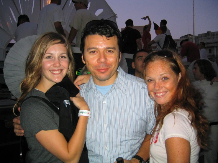 three people standing in front of people at an event