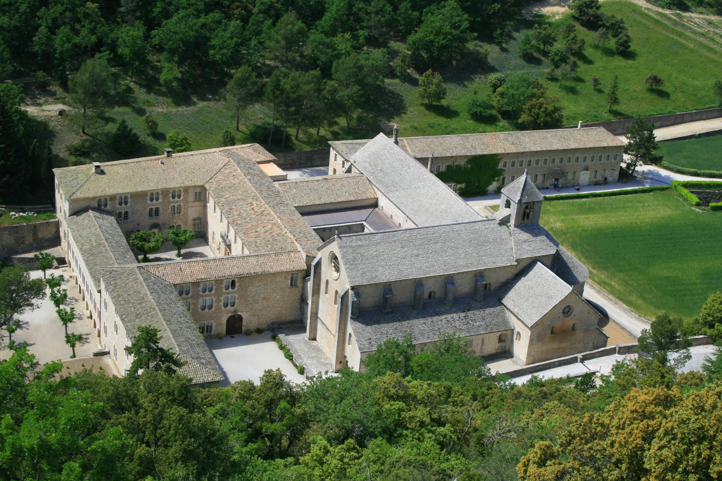 an aerial view of a building surrounded by trees