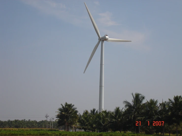 a large white windmill in a rural area