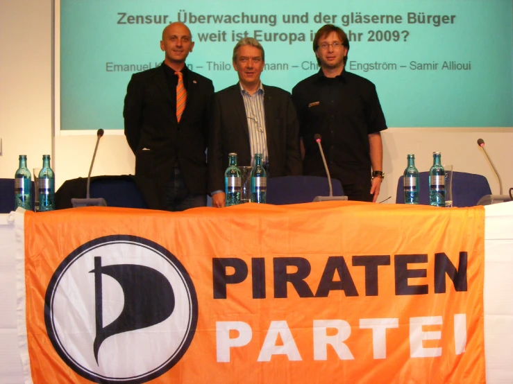 three men are posing on a podium for a po