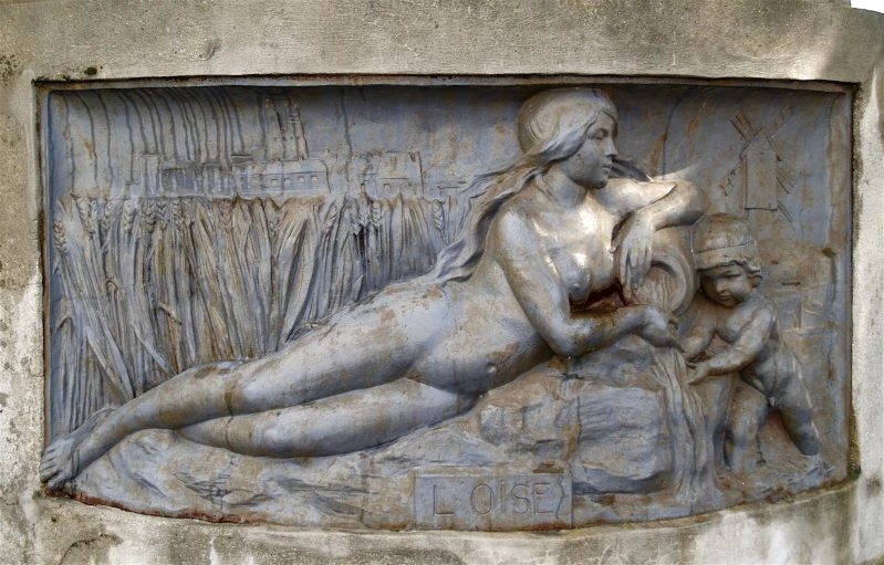 an antique statue depicting a reclining woman