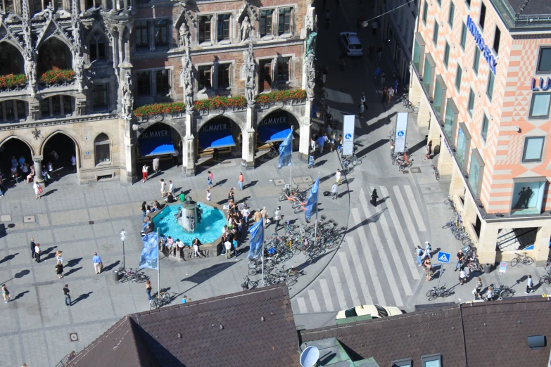 a town square features an ornate fountain surrounded by pedestrians